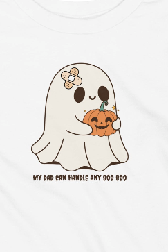 A white short-sleeve t-shirt featuring a cute cartoon graphic of a ghost with a band-aid on its head and a smiling orange pumpkin in its paws, with the text 'MY DAD CAN HANDLE ANY BOO BOO' underneath.